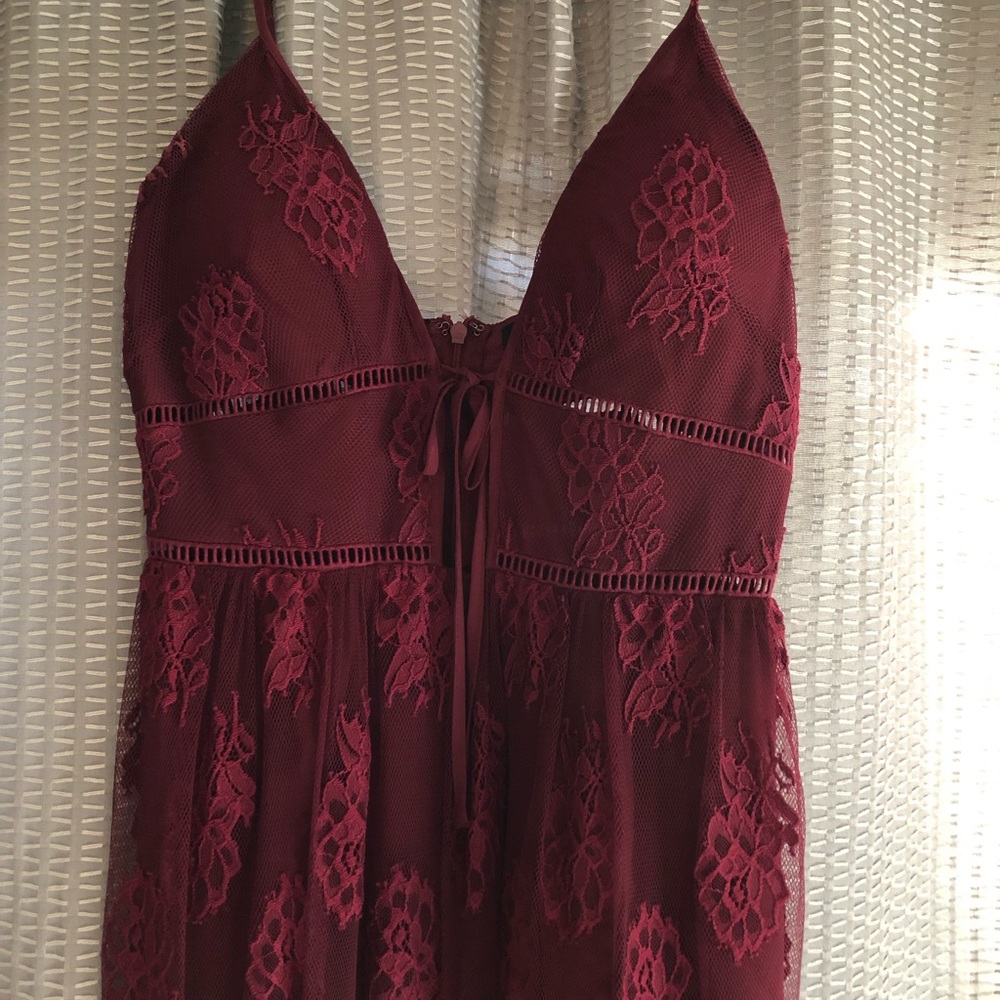 Floor length, maroon dress with lace details.